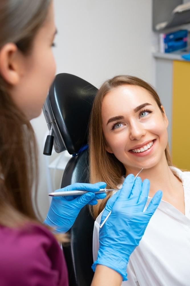 Patient smiling at her dental hygienist
